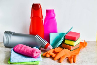 Temizlik ve düzenleme için hazır, mutfak masasında aksesuarlar, beyaz arka planda. Metin için yer.