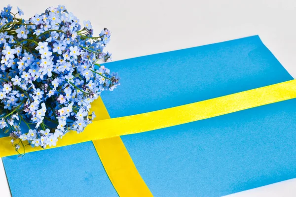 Swedish flag from ribbons isolated on a white background with flowers. June 6th. Celebration. Sweden National Day. Swedish flag day