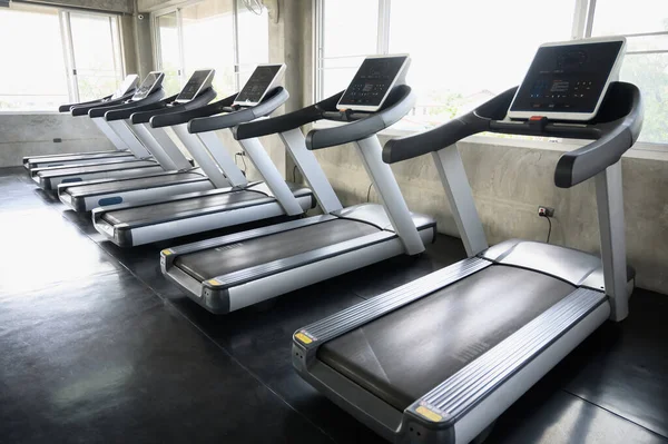 Rows of Treadmills in the gym background for banner presentation. Themes about exercise for good health.