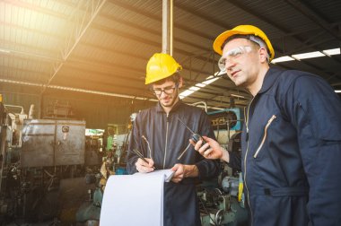 Endüstriyel işçiler büyük sanayi tesislerinde pek çok cihazlı projeler üzerinde çalışıyorlar..