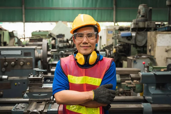 Asian Industrial workers are working on projects in large industrial plants with many devices.