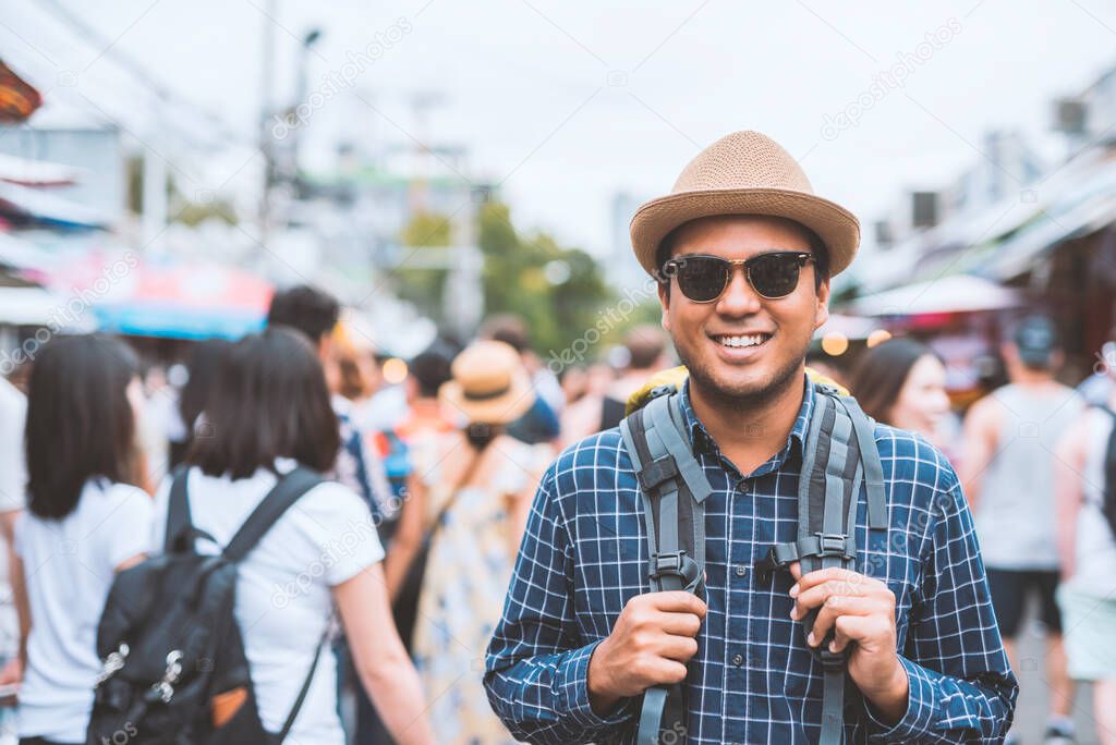 Traveling man walking at Chatuchak Market in Bangkok Thailand.