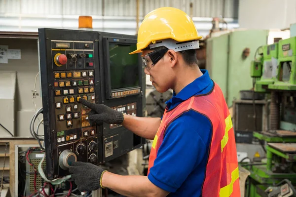 Asian Industrial workers are working on projects in large industrial plants with many devices.