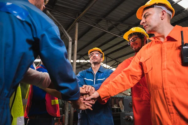 The industrial worker team in a large industrial factory with many equipment.