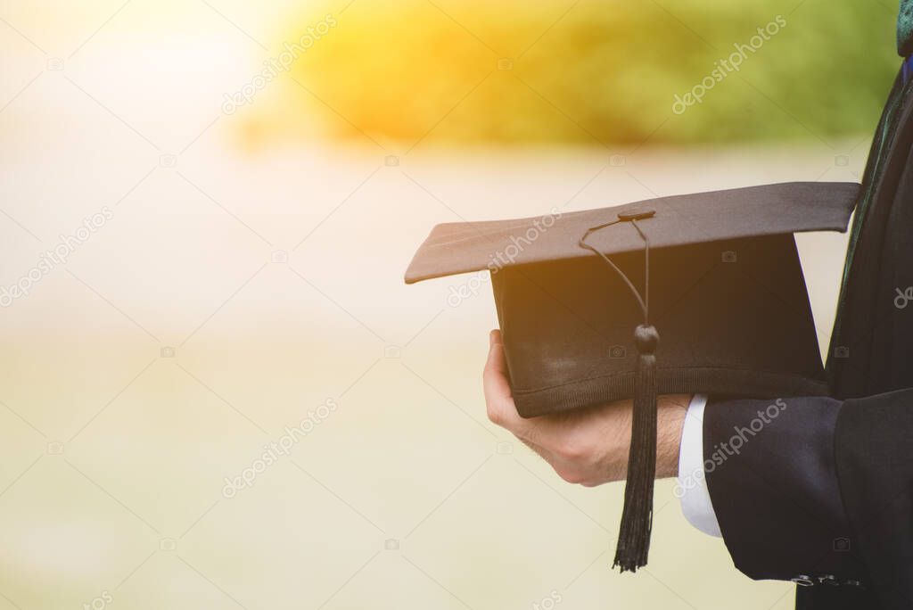 Close up Graduate holding a hat. Concept success education in University with copy space.