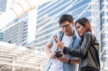 Gezgin bir aşık turistik yerleri bulmak için akıllı telefon kullanıyor. Seyahat, alışveriş ve tatil konsepti.