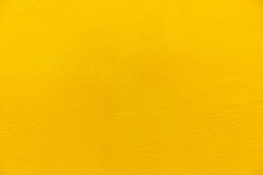 Bulanık sarı sıva duvar arkaplanı. Sarı boyanmış beton duvar dokusu.