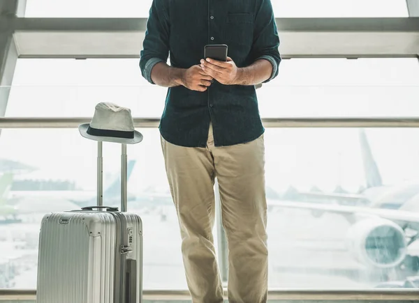 Tourists are checking tour programs from their smartphones at the airport.