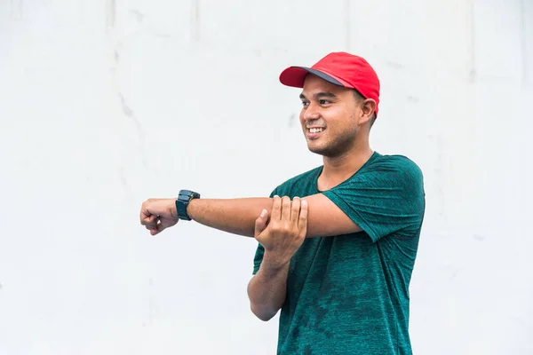 Young fitness man runner stretching before run with copy space.