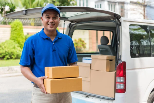 Deliver man in blue uniform and parcel cardboard box