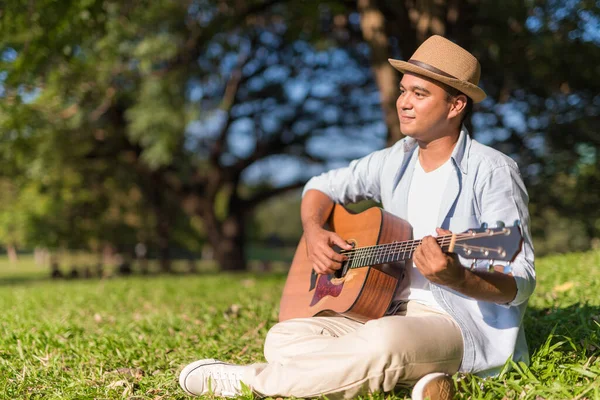 Young Asian Man Playing Guitar Park Stock Photo