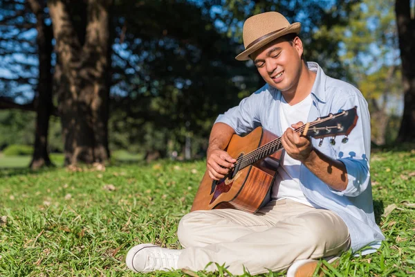 Young Asian Man Playing Guitar Park Stock Photo