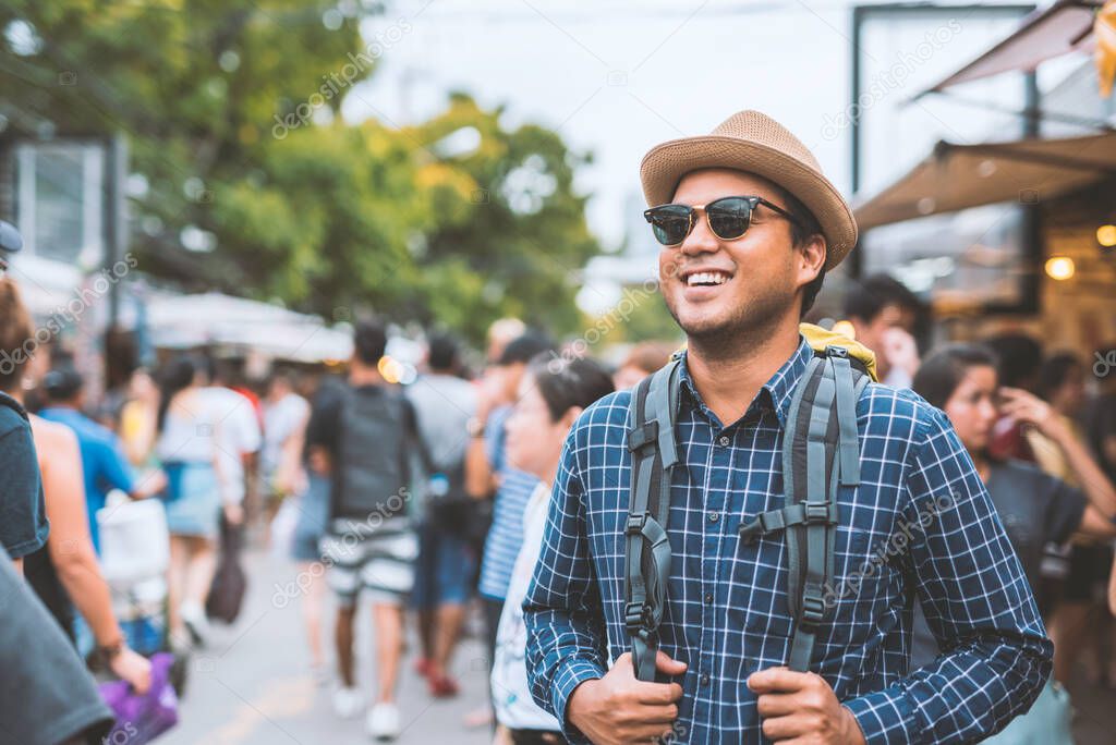 Traveling man walking at Chatuchak Market in Bangkok Thailand.