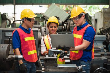 Endüstriyel işçiler, büyük bir endüstriyel fabrikada çeşitli projeler üzerinde çalışıyor..