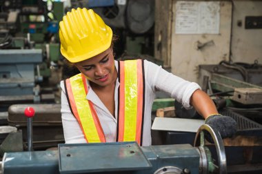 Kadın endüstriyel işçiler büyük bir endüstriyel fabrikada çalışıp kontrol ediyorlar..
