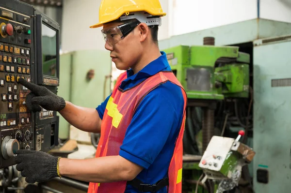 Asian Industrial workers are working on projects in large industrial plants with many devices.