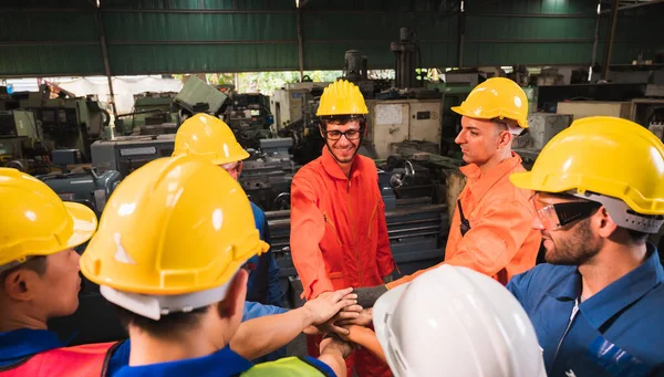 The industrial worker team in a large industrial factory with many equipment.