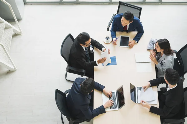 Top view of  asian business people team analyzing statistics financial. High angle view of a team of businesspeople Meeting Conference Discussion Corporate Concept in office.