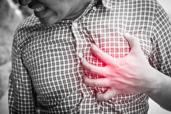 Young man having heart attack