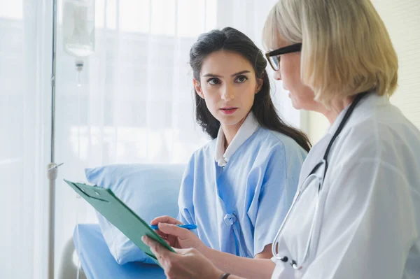 Senior Female Doctor Meet Patient Discussing Consultation Making Notes Symptom — Stock Photo, Image