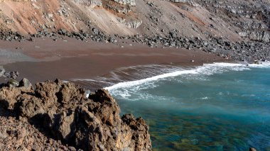 Red sand beach, El Verodal on the Island of El Hierro. clipart