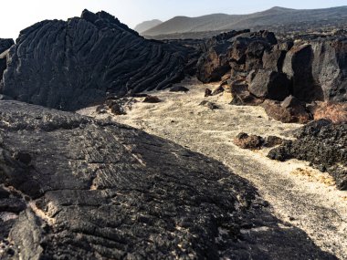 Lava flows in La Restinga. We can observe two types of lava: pahoehoe or cordada and aa or escoriacea. clipart