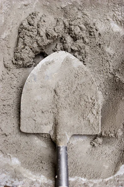 SHOVEL IN WET CEMENT