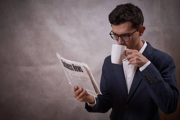 Man reading newspaper, business news, fake news, finance, news, morning coffee, gazette