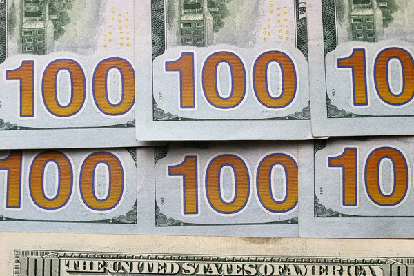US dollars, face value of banknotes of 100 dollars, background.
