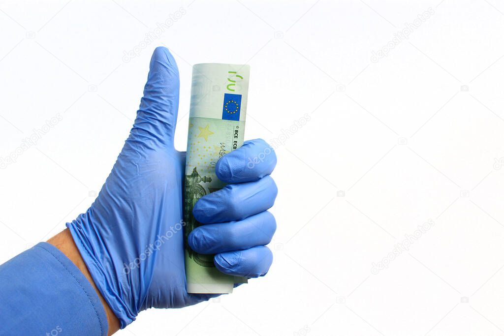 A hand in a medical glove holds the euro on a white background, isolated. Pandemic Crisis Response Concept