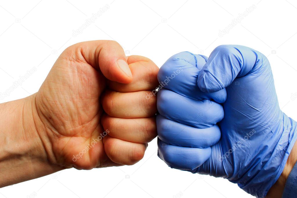 Two fists, one of them in a medical glove on a white background, isolated. Pandemic Control Concept