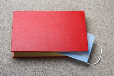 Tıbbi ya da cerrahi maske kitaplarda yer imi görevi görür. Harfler ya da metinler için yeri var. Karantina ve kendini izole etme kavramı.