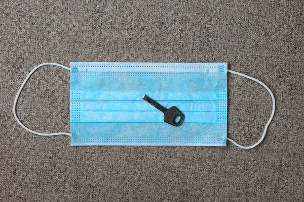 The key lies on a medical surgical mask, health secret concept