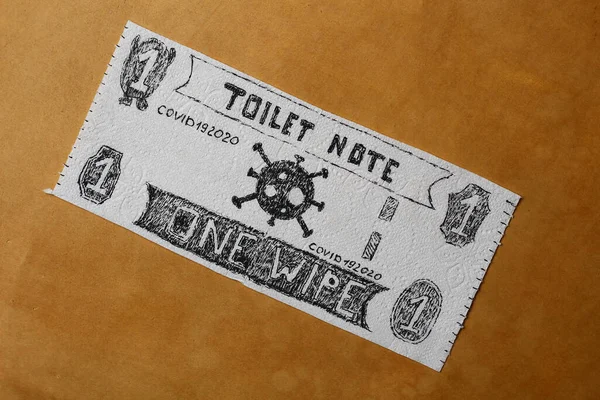 Money comic bill or note drawn on toilet paper. Panic shopping concept. Light brown background