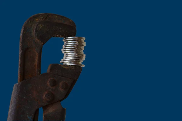 Plumbing Pipe Wrench Compresses Coins Deep Blue Background — Stock Photo, Image