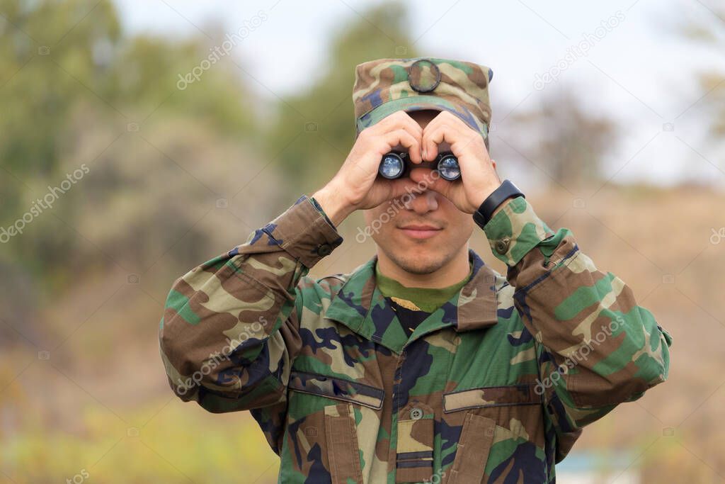 Soldier looking through binoculars people young man