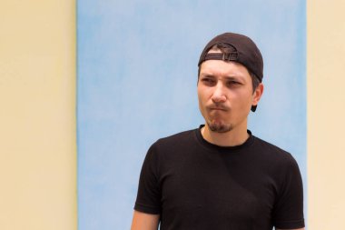 The offended man sadly with anger looks into the distance. Emotion: Alright, alright, I'll show you all, bitches