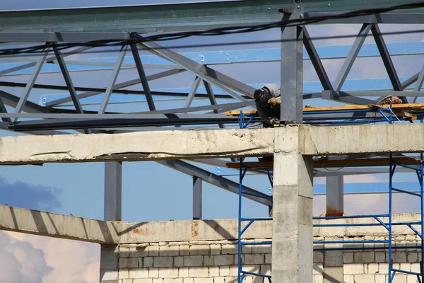 Welder does his job on building a typical commercial property