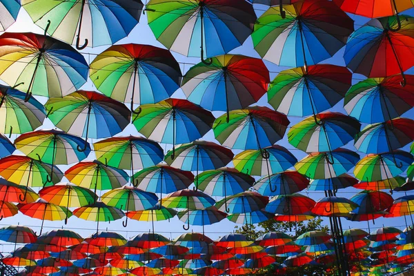 Beautiful bright multi-colored umbrellas, a symbol of summer tourism background