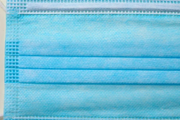 Close-up texture of a medical surgical mask required to be worn in public places during a pandemic of an infectious disease