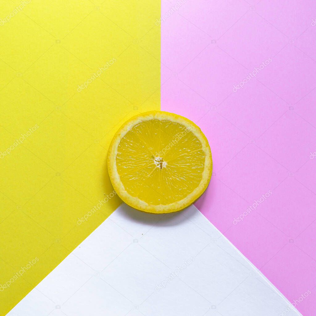 Minimal food concept. Lemon on a bright yellow background. Free space for text. Top view. Minimalism. Creative citrus