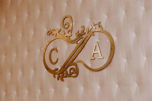 gold newlywed logo on the wall