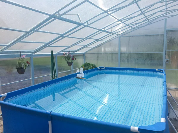 Şeffaf bir polikarbonat köşkünde, şeffaf su dolu küçük mavi çerçeve havuz, hayat dolu, kır tatili, yaz tatili.