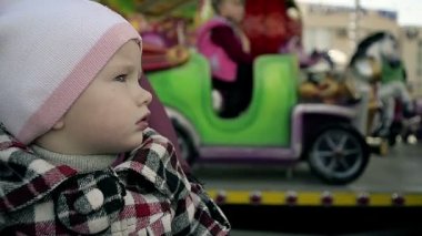 Carousel eğlence parkı olan küçük bir kız close-up ağır çekim