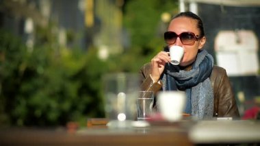 Mutlu genç kadın bir açık havada Cafe yalnız kahve içmek