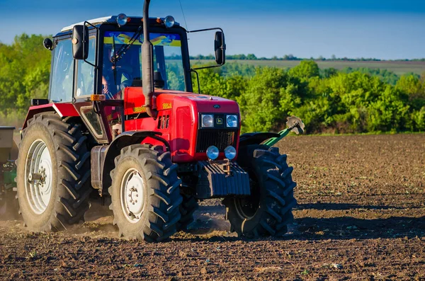 Close-up een tractor op landbouwgebied zaait het veld met zaden. — Stockfoto