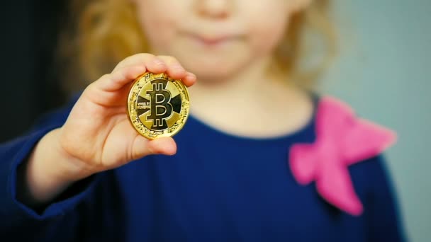 Slow Motion Close Little Girl Three Years Holding Gold Bitcoin — Stock Video