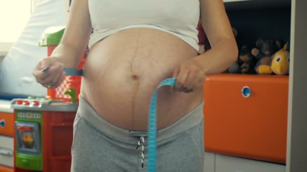 Close Young Pregnant Girl Measures Volume Her Belly Children Room — Stock Video