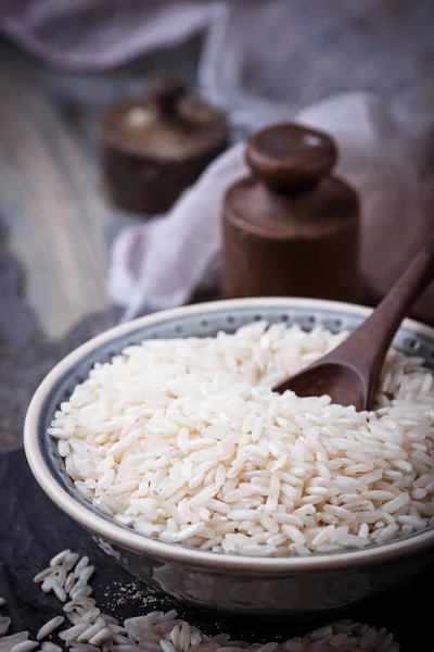 White uncooked rice on concrete background