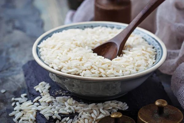 Witte ongekookte rijst op concrete achtergrond — Stockfoto